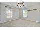 Bedroom with neutral-colored walls, carpet flooring, a ceiling fan, and two windows for natural light at 330 Albrighton Way, Moncks Corner, SC 29461