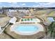 Aerial view of the community pool, playground, and amenity center with parking in a residential neighborhood at 330 Albrighton Way, Moncks Corner, SC 29461