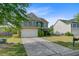 Two-story home featuring a well-manicured lawn, a two-car garage, and classic design at 330 Albrighton Way, Moncks Corner, SC 29461