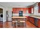 Charming kitchen with stainless steel appliances, wood cabinets, and an island with seating at 330 Albrighton Way, Moncks Corner, SC 29461