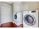 A well-lit laundry room with modern washer and dryer units, providing convenience and efficiency at 330 Albrighton Way, Moncks Corner, SC 29461