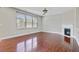 Cozy living room with hardwood floors, a fireplace, and abundant natural light at 330 Albrighton Way, Moncks Corner, SC 29461