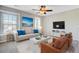 Inviting living room with a cozy seating area, bright natural light, and a modern ceiling fan at 330 Albrighton Way, Moncks Corner, SC 29461