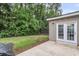 Cozy backyard with a small patio, perfect for relaxing and entertaining with mature trees and greenery at 3844 Annapolis Way, Ladson, SC 29456