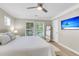 Bright bedroom featuring neutral walls, a ceiling fan, a flat-screen TV, and windows with tree views at 3844 Annapolis Way, Ladson, SC 29456