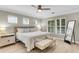 Bright bedroom with neutral walls, multiple windows, a ceiling fan, and a large bed with a bench at the foot at 3844 Annapolis Way, Ladson, SC 29456