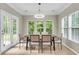 Bright dining room with modern lighting, a view to the backyard and room for entertaining at 3844 Annapolis Way, Ladson, SC 29456