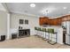 Well-appointed kitchen with a breakfast bar, dark wood cabinets, stainless steel appliances, and ample counter space at 3844 Annapolis Way, Ladson, SC 29456