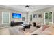 Comfortable living room featuring a ceiling fan, large windows, and contemporary furnishings at 3844 Annapolis Way, Ladson, SC 29456