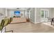 Bright living room features hardwood floors, a large TV, neutral colors, and French doors to the backyard at 3844 Annapolis Way, Ladson, SC 29456