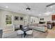 Spacious living room with a modern ceiling fan, plush seating, and natural light at 3844 Annapolis Way, Ladson, SC 29456