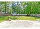 Large fenced-in backyard featuring lush grass, shed, fire pit, and mature trees at 403 Forest Cir, Summerville, SC 29483