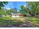 Expansive backyard includes a cozy fire pit, a concrete patio, and solar panels on the house at 403 Forest Cir, Summerville, SC 29483