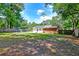 View of the home's backyard with wood fence, fire pit, and solar panels at 403 Forest Cir, Summerville, SC 29483
