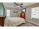 A cozy bedroom features natural light, a ceiling fan, and hardwood floors at 403 Forest Cir, Summerville, SC 29483