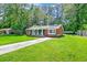 Charming brick home with a well-manicured lawn, inviting front porch, and solar panels on the roof at 403 Forest Cir, Summerville, SC 29483
