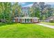 Charming brick home with inviting front porch, lush lawn, and mature trees at 403 Forest Cir, Summerville, SC 29483