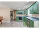 Well-lit kitchen boasts abundant green cabinetry, modern appliances, and practical layout at 403 Forest Cir, Summerville, SC 29483