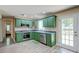 Updated kitchen with stainless appliances, green cabinets, and tile flooring at 403 Forest Cir, Summerville, SC 29483