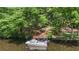 Waterfront dock with a boat, surrounded by lush trees and offering easy access to tranquil waters at 418 Lakeview Dr, Summerville, SC 29485