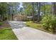 A long driveway leads to a well-maintained brick home with lush landscaping and a two car garage at 418 Lakeview Dr, Summerville, SC 29485