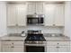 Updated kitchen with stainless steel appliances, granite countertops, and white cabinets at 418 Lakeview Dr, Summerville, SC 29485