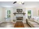 Bright living room featuring a decorative fireplace, ceiling fan, and hardwood floors at 418 Lakeview Dr, Summerville, SC 29485