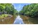 Lush waterfront with a private dock, offering serene water views and boating access amid lush greenery at 418 Lakeview Dr, Summerville, SC 29485