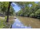 Peaceful waterfront with a private dock, framed by lush greenery and serene water views at 418 Lakeview Dr, Summerville, SC 29485