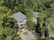 Aerial view featuring the main house with a large front porch and the cottage surrounded by trees at 418 W Carolina Ave, Summerville, SC 29483