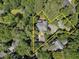 Aerial view of a tree-lined property highlighting the location of the house and its surrounding land at 418 W Carolina Ave, Summerville, SC 29483