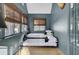 Charming bedroom with trundle bed, neutral bedding, natural light, and hardwood floors with decorative floral details at 418 W Carolina Ave, Summerville, SC 29483