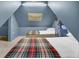 Cozy bedroom with twin beds, plaid blankets, overhead lighting, and natural light at 418 W Carolina Ave, Summerville, SC 29483