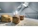 Attic bonus room with comfortable seating on top of a hide rug and a vaulted ceiling at 418 W Carolina Ave, Summerville, SC 29483