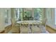 Bright dining room with large windows, chandelier, and oval table with seating for six at 418 W Carolina Ave, Summerville, SC 29483