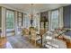 Elegant dining room with a chandelier, long table, and multiple windows at 418 W Carolina Ave, Summerville, SC 29483