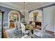 Bright dining room with a chandelier, long table, and arched doorways at 418 W Carolina Ave, Summerville, SC 29483