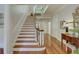 Grand entryway features hardwood floors, staircase, and natural light at 418 W Carolina Ave, Summerville, SC 29483