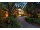 A long driveway leads up to this beautiful home, surrounded by lush greenery at 418 W Carolina Ave, Summerville, SC 29483