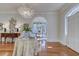 Elegant foyer with hardwood floors, a table with fern, and an arched doorway at 418 W Carolina Ave, Summerville, SC 29483