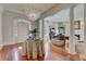 Grand foyer with a chandelier, hardwood floors, and arched doorways seamlessly connect the living spaces at 418 W Carolina Ave, Summerville, SC 29483