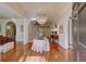 Grand foyer features a striking chandelier, hardwood floors, and arched doorways for a luxurious entrance at 418 W Carolina Ave, Summerville, SC 29483