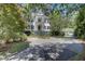 Two-story home featuring a double balcony, manicured landscaping, and circular driveway for curb appeal at 418 W Carolina Ave, Summerville, SC 29483