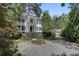 Two-story home featuring a double balcony, manicured landscaping, and circular driveway for curb appeal at 418 W Carolina Ave, Summerville, SC 29483
