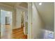 Hallway featuring hardwood floors, multiple entryways, and views of the kitchen and a bathroom at 418 W Carolina Ave, Summerville, SC 29483