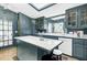 Open kitchen with large island, white countertops, stainless steel appliances, and a skylight at 418 W Carolina Ave, Summerville, SC 29483