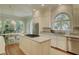 Open kitchen with island cooktop and adjacent dining area with a large window at 418 W Carolina Ave, Summerville, SC 29483