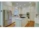 Gourmet kitchen features stainless steel appliances, center island, and plenty of storage at 418 W Carolina Ave, Summerville, SC 29483