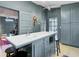 Large kitchen with island, stainless steel microwave, custom blue cabinets and light hard wood floors at 418 W Carolina Ave, Summerville, SC 29483