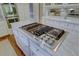 Close up of the kitchen island cooktop with stainless steel knobs and marble countertop at 418 W Carolina Ave, Summerville, SC 29483